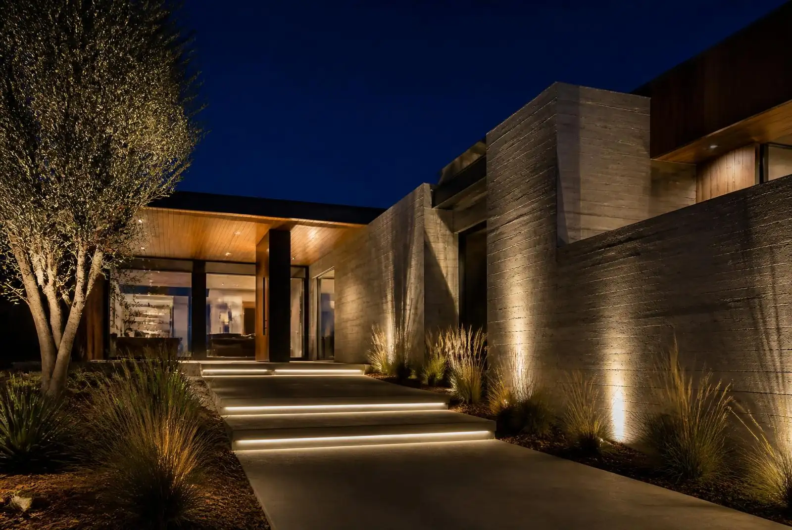 Aliso Viejo modern contemporary home with subtle in-grade path lighting at night
